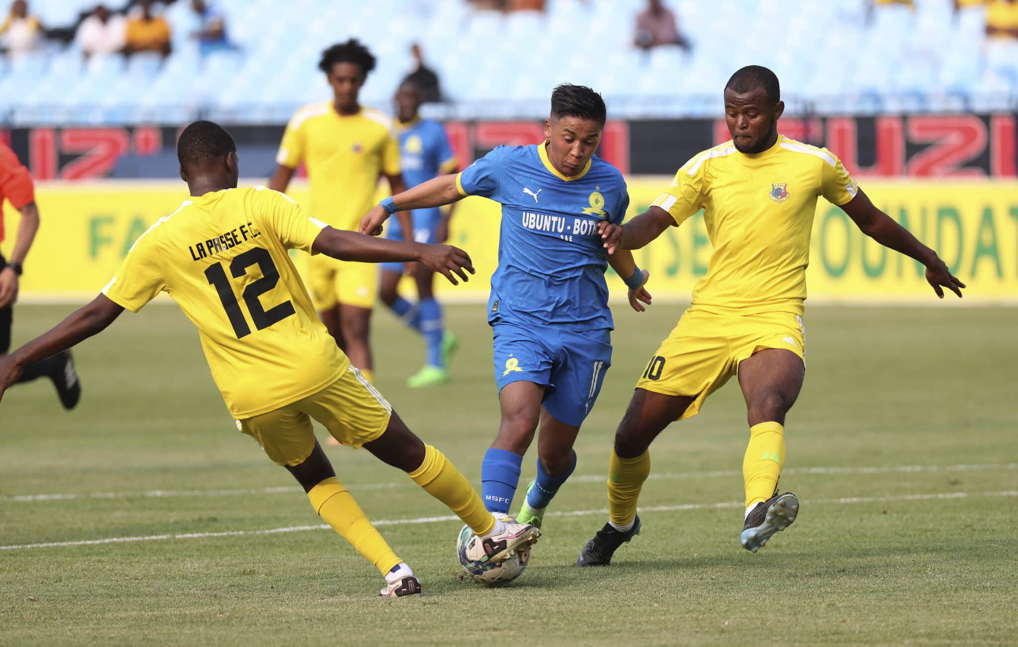 Marcelo Bravo Allende of Mamelodi Sundowns challenged by Jean Yves Choisy and Rhino Michel Randriamanjaka of La Passe