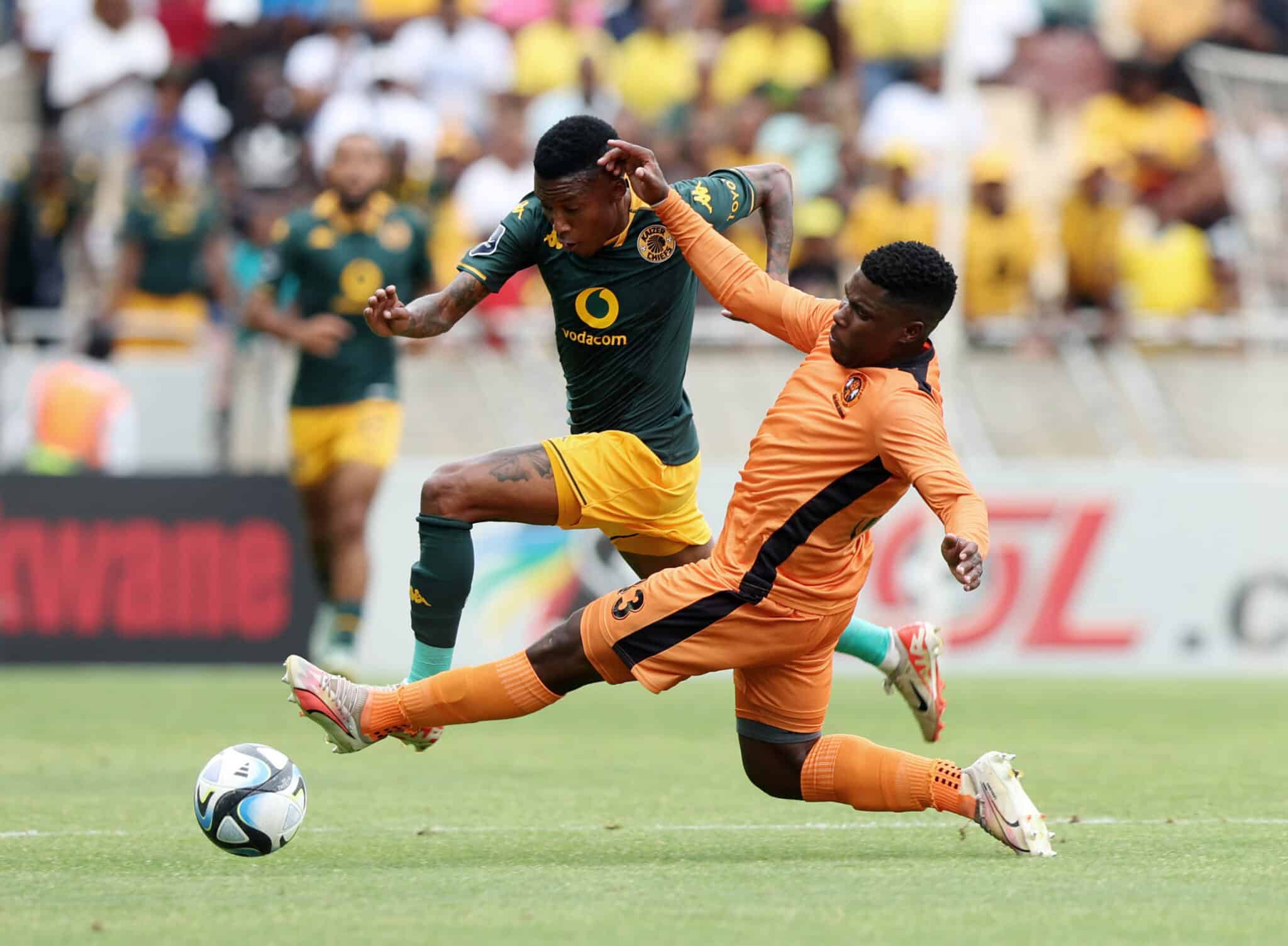 Pule Mmodi of Kaizer Chiefs tackled by Langelihle Ndlovu of Polokwane City