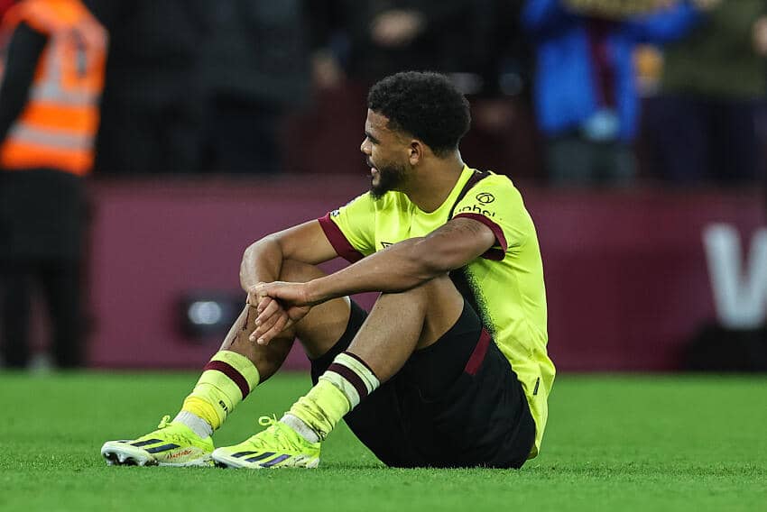 Burnley forward, Lyle Foster sitting down on the pitch