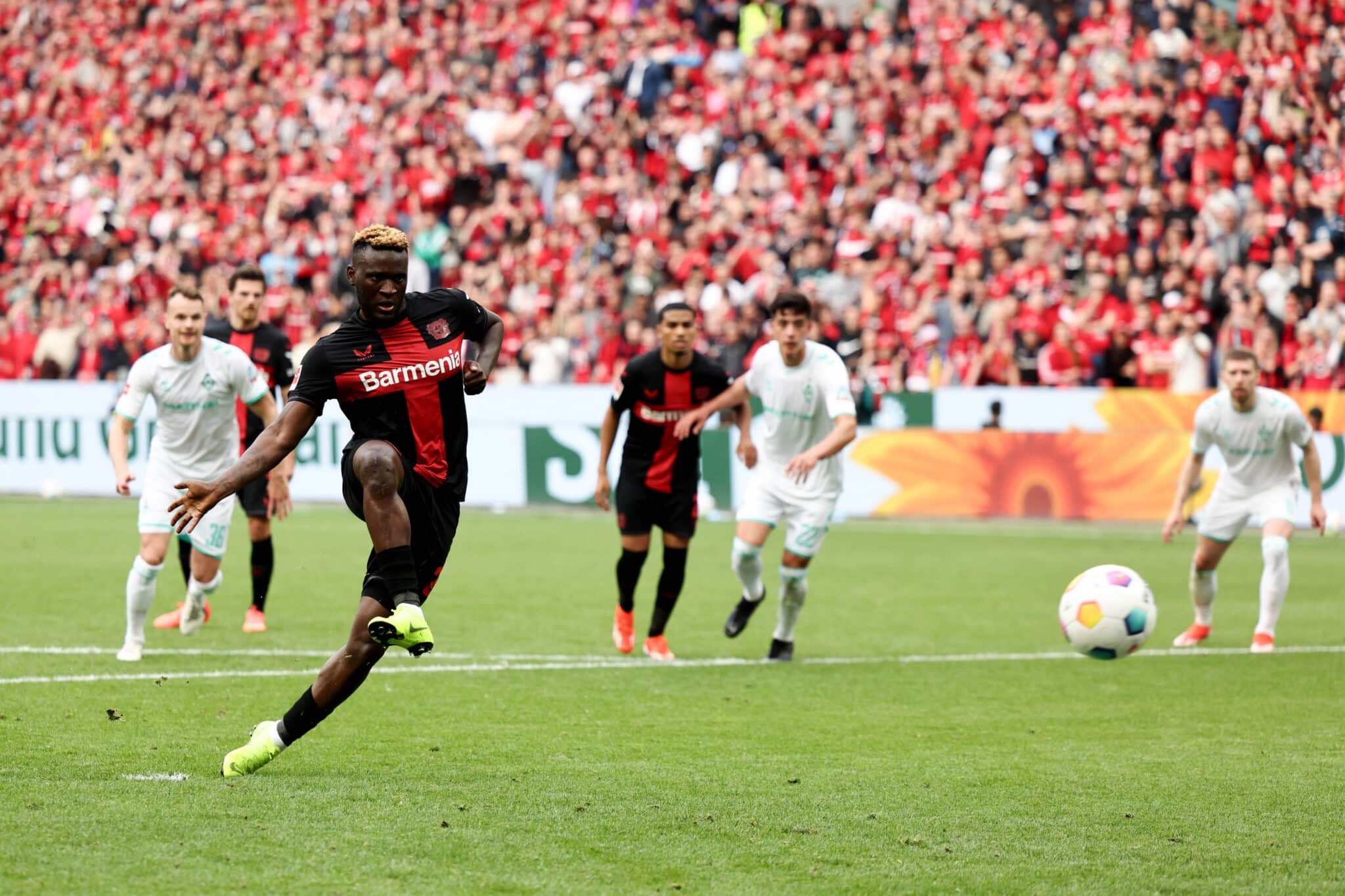 Victor Boniface scores from the penalty spot to set the Bundesliga title party rolling